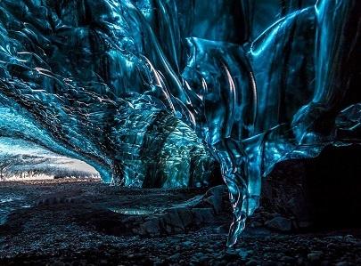 Crystal blue ice cave tour on Vatnajökull Glacier in Iceland.
